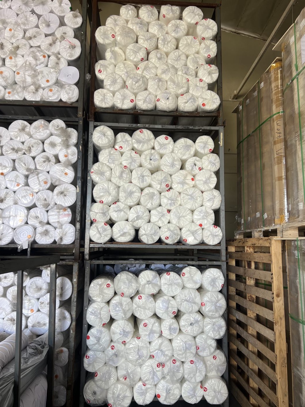 Bagged polyester fabric rolls racked by lot
